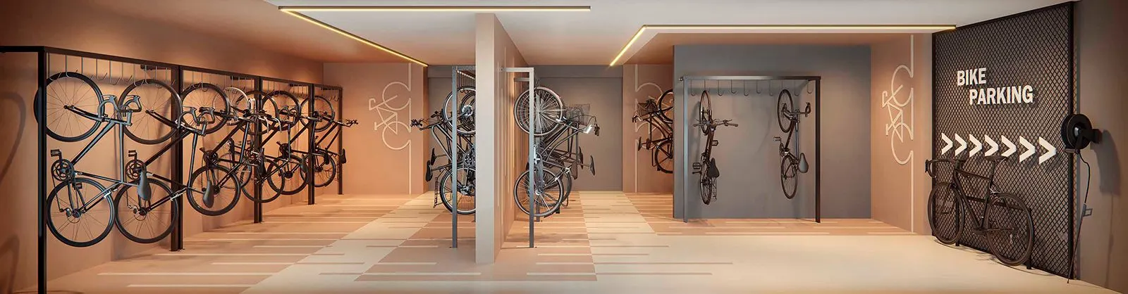 O bicicletário, com bicicletas penduradas nas paredes e o espaço de manutenção ao fundo.