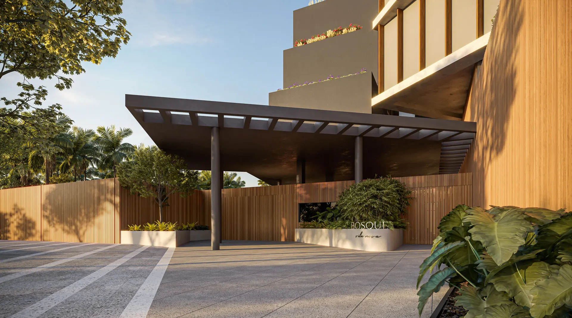 O porte-cochère da Rua Domingos Fernandes: uma cobertura escura sobre a entrada de carros, com paredes de madeira, jardim e a base da torre ao fundo.
