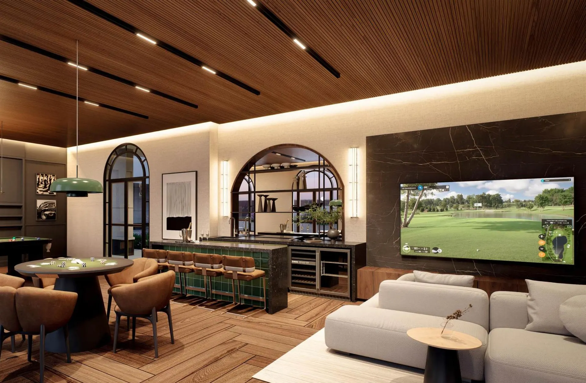 O lounge family, com mesa de jogos, bar e um telão diante dos sofás.