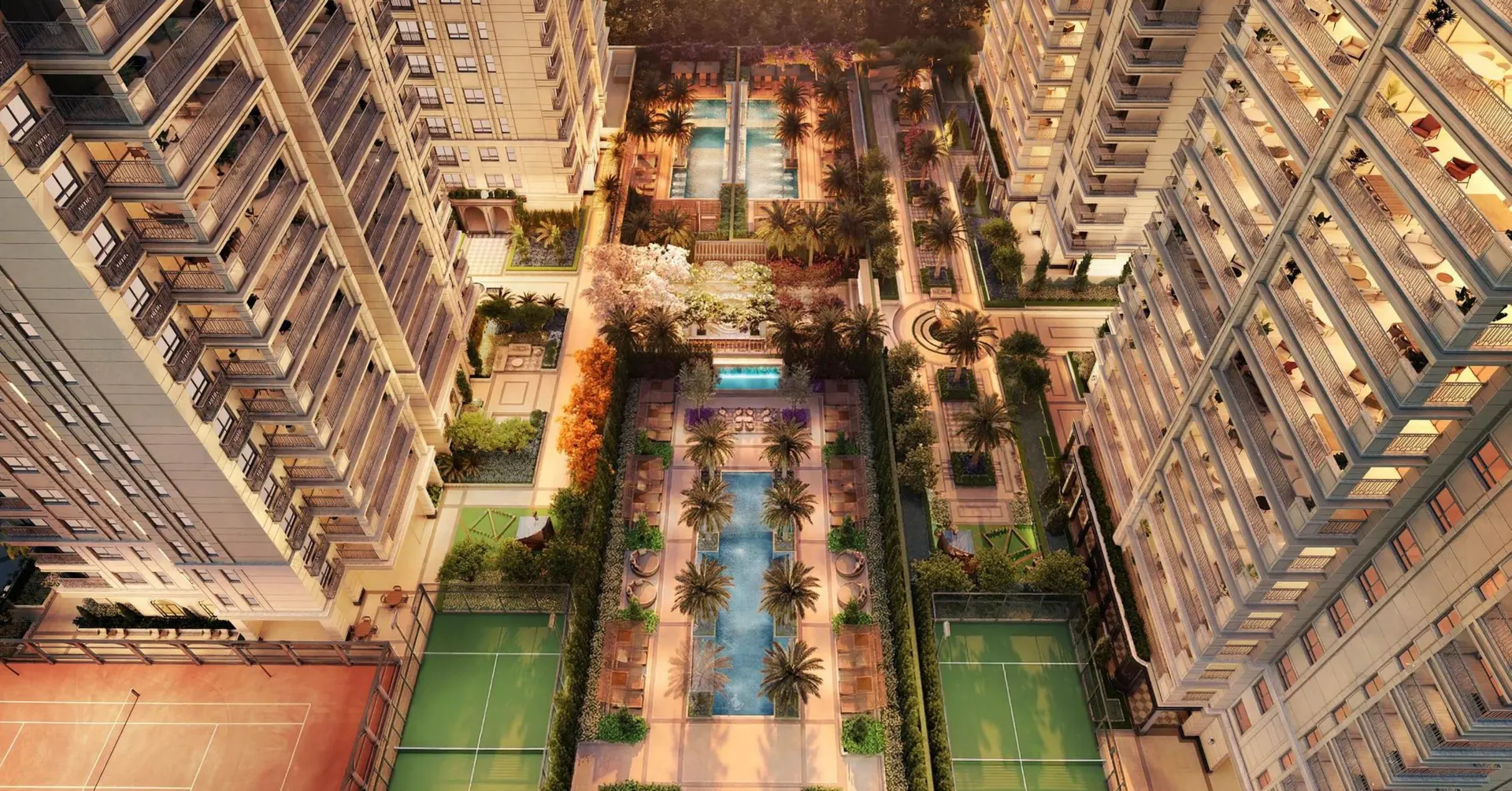 O jardim entre as quatro torres visto do alto: espelhos d'água, piscinas, palmeiras e as quadras de saibro e de padel.