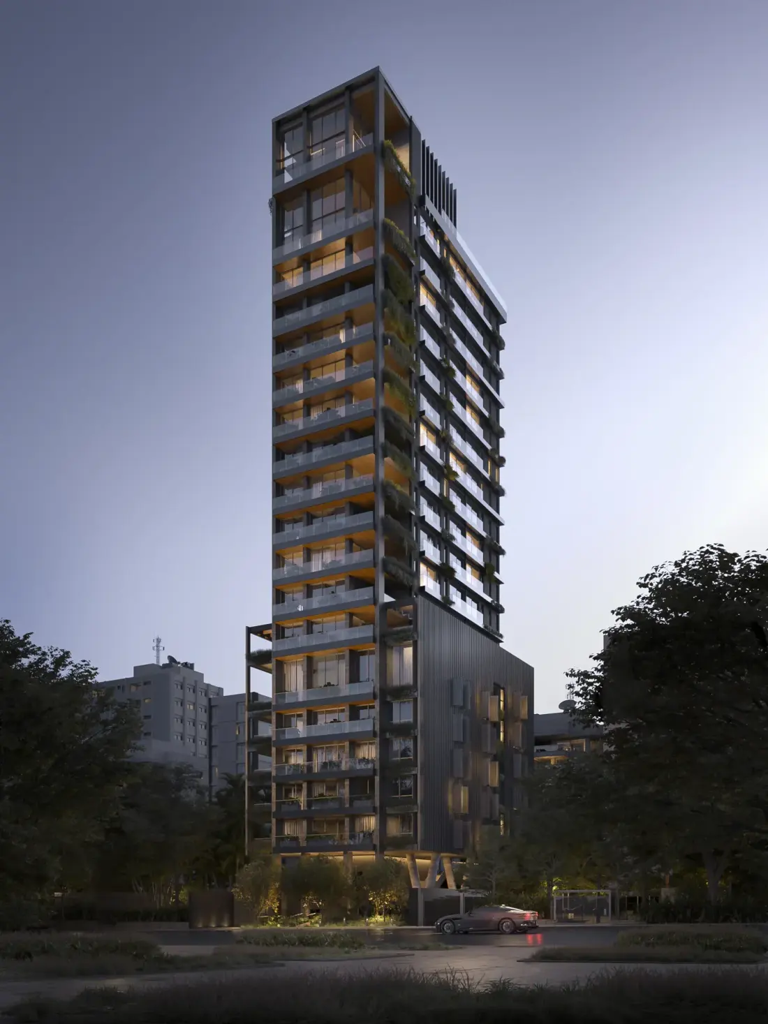 A torre do Edifício Jardim ao entardecer, alta e estreita, com as varandas acesas andar por andar e as jardineiras na fachada escura, entre as árvores da rua e o céu azul.