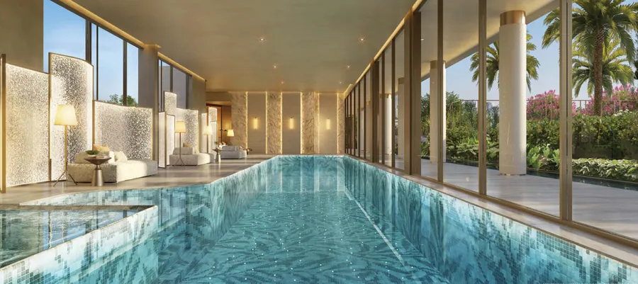 Piscina coberta com raia de 25 metros, cercada de vidro e vegetação.