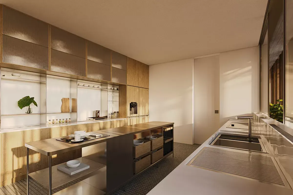 Uma cozinha clara: a bancada de inox com cuba dupla, a ilha com gavetas e os armários de madeira e vidro.