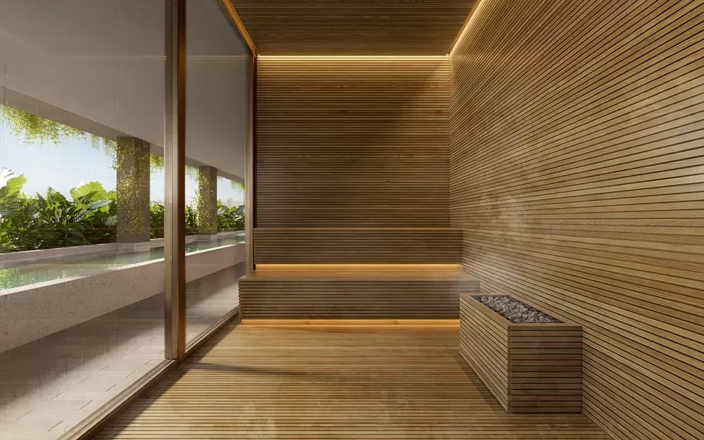 A sauna seca revestida de ripas de madeira, com o banco e a luz embutida, e uma janela para o jardim.