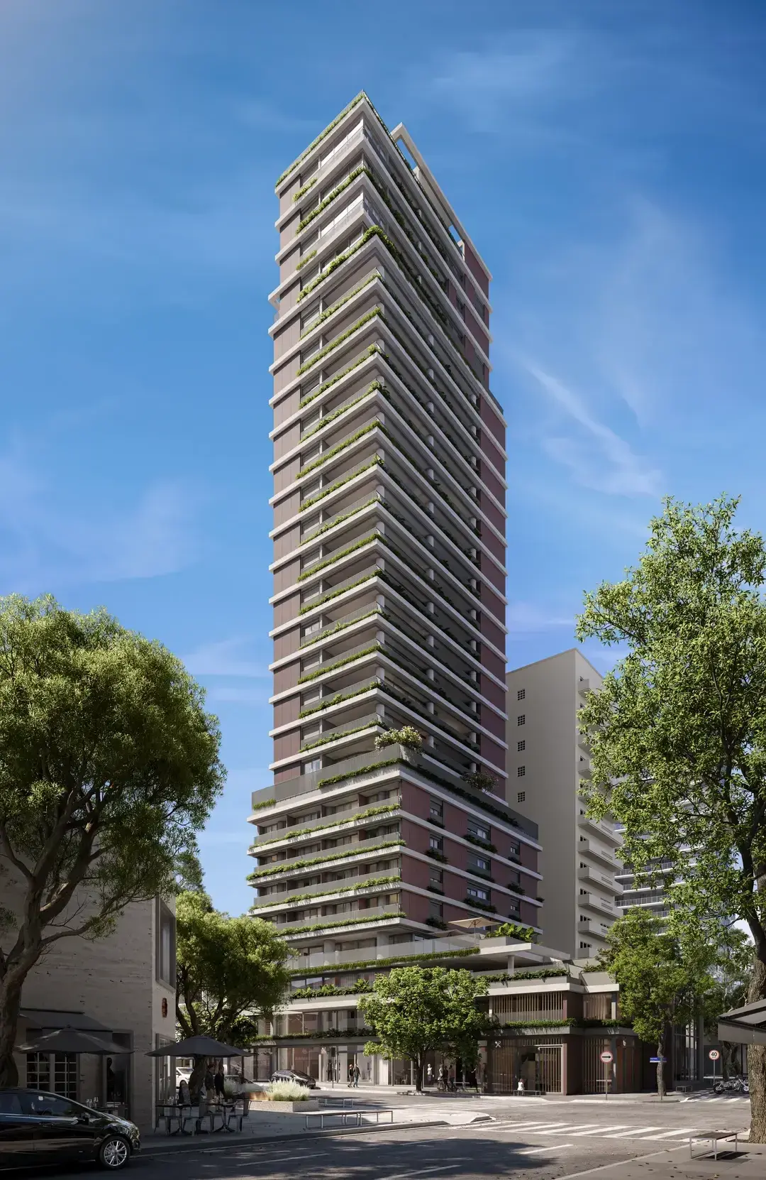 A torre do Oscar 900 inteira, de dia, vista da esquina: alta e estreita, com as varandas de jardineiras em todos os andares, a base envidraçada e as árvores da calçada.