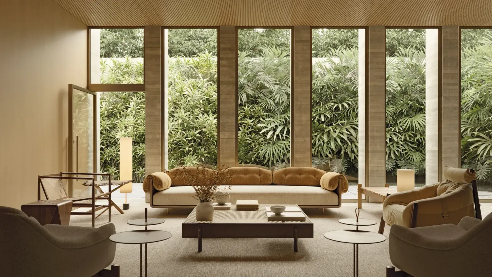 O salão de festas: os sofás e as poltronas em volta de uma mesa baixa, o forro de madeira e as janelas altas com a vegetação lá fora.