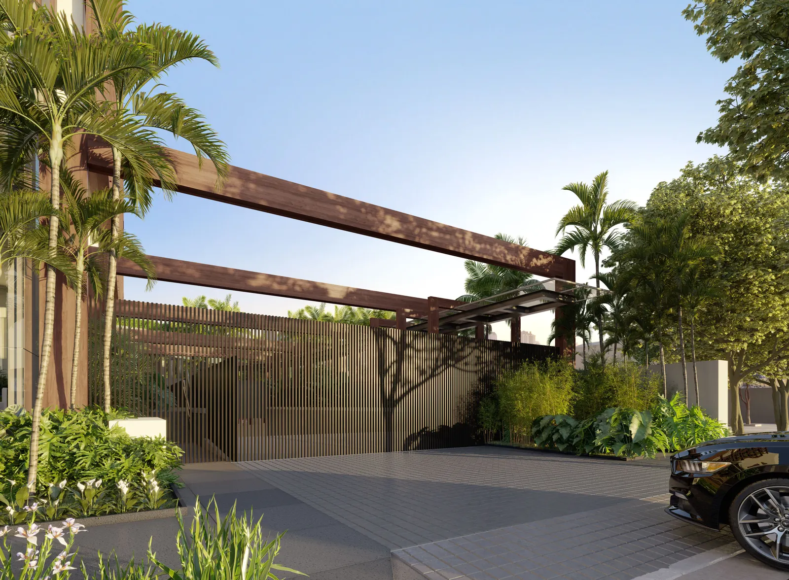 O acesso residencial da Rua Henrique Monteiro: uma pérgola de madeira escura sobre a entrada de carros, palmeiras e um jardim tropical.